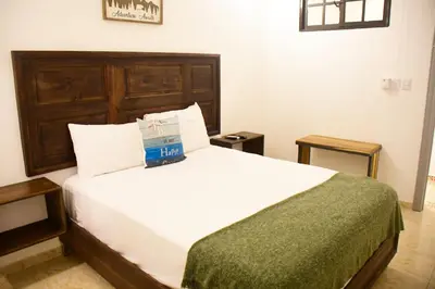 a hotel room with a bed with a box on it at Hostal Marina Samana in Santa Bárbara de Samaná
