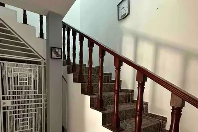 a staircase with a clock on the side of a building at Casa Linda - 10 mins from Beach & Lagoon with AC & Free Parking in Payita
