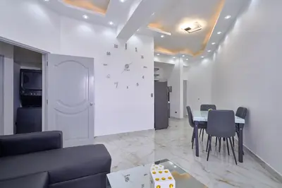 a living room with a table and chairs at spectacular sea view in Santo Domingo