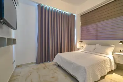 a bedroom with a white bed and a window at spectacular sea view in Santo Domingo