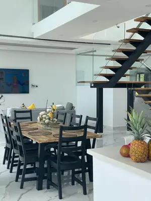 a dining room with a wooden table and chairs at Villa Ocean Blue in Las Terrenas