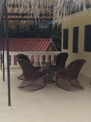 a group of chairs sitting on a patio at Sana El Jardin Secreto in Santiago de los Caballeros