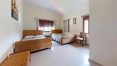 a living room with two beds and a table at Green Paradise in Juan Dolio