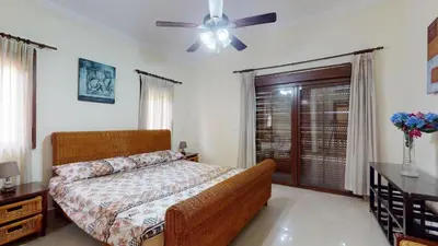 a bedroom with a bed and a ceiling fan at Green Paradise in Juan Dolio