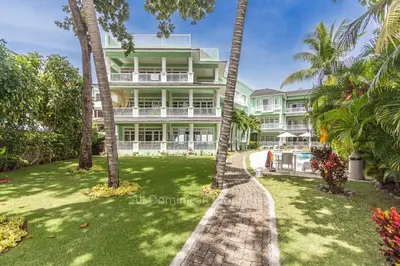 an apartment building with palm trees in front of it at 