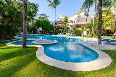a swimming pool in a resort with palm trees at 