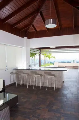 a room with a bar with stools in a building at Modern and centric Apartment with pool and gym at Downtown in Santo Domingo