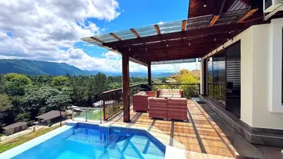 a house with a swimming pool and a deck at Vista del Campo Country Club & Villas in Jarabacoa