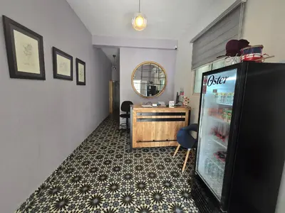 a hallway with a refrigerator and a table in it at Hostal 53 Boutique Santo Domingo in Santo Domingo