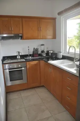 a kitchen with a sink and a stove top oven at Apartamento con vista a la piscina in Las Terrenas