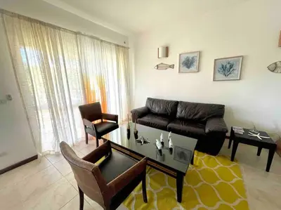 a living room with a couch and a table at Apartamento con vista a la piscina in Las Terrenas