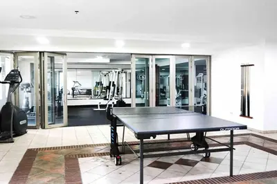 a gym with a ping pong table in a room at Beach Front Penthouse in Exclusive Tower in Santo Domingo