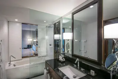 a bathroom with a sink and a tub and a mirror at JW Marriott Hotel Santo Domingo in Santo Domingo