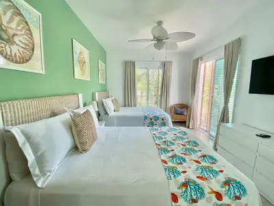 a large bedroom with two beds and a couch at Stunning Beachfront Condo With Private Beach, Las Terrenas-El Limón in El Limón