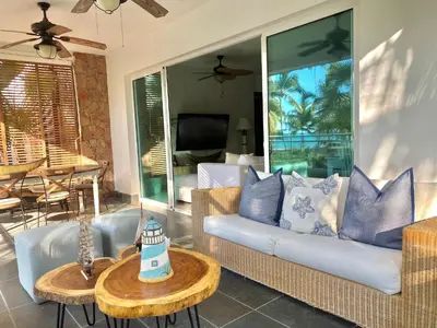 a living room with a couch and a table at Stunning Beachfront Condo With Private Beach, Las Terrenas-El Limón in El Limón