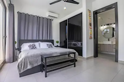 a bedroom with a large bed and a mirror at Sosua Ocean Village, Villa 9 Campo Del Mar , IV in Sosúa