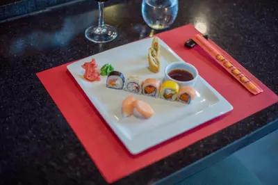 a plate of sushi on a table with chopsticks at Iberostar Waves Costa Dorada - All Inclusive in San Felipe de Puerto Plata