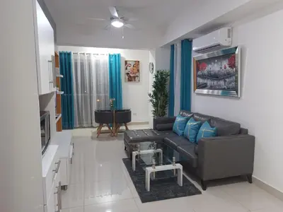 a living room with a couch and a table at Simply the most comfortable place next to Boca Chica beach in Boca Chica
