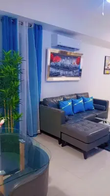 a living room with a couch with blue pillows at Simply the most comfortable place next to Boca Chica beach in Boca Chica