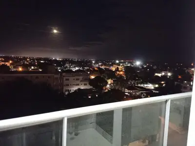 a view of a city at night from a balcony at Simply the most comfortable place next to Boca Chica beach in Boca Chica