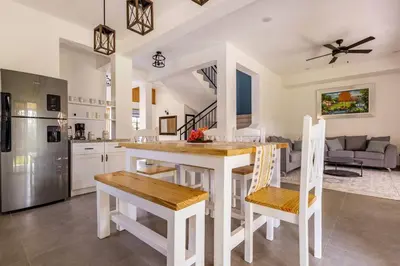 a kitchen with a table and some chairs in a kitchen at Villas Elim A and B in Cabrera