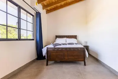 a bedroom with a bed and a large window at Villas Elim A and B in Cabrera