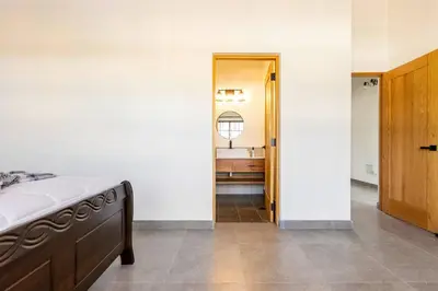 a bedroom with a bed and a hallway with a bathroom at Villas Elim A and B in Cabrera