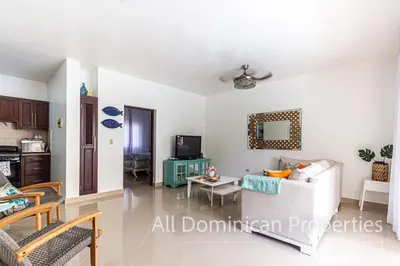 a living room with a couch and a table at Paradise Condos, Cabarete! in Cabarete