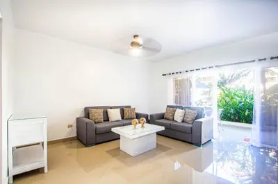 a living room with a couch and a table at Paradise Condos, Cabarete! in Cabarete
