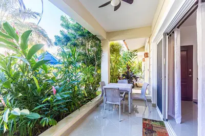 a patio with a table and chairs and plants at Paradise Condos, Cabarete! in Cabarete