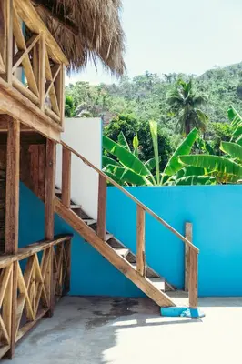 a staircase to a house with a blue wall at Parador El Ermitaño in Santa Bárbara de Samaná