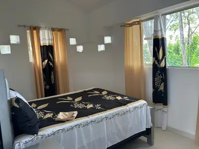 a bedroom with a bed and a window at Tropical Optimal Tropicana Sur in Sosúa