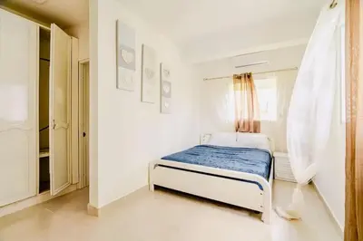 a bedroom with a bed in a white room at Villa Vintage. in Boca Chica