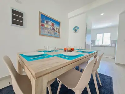 a dining room with a wooden table and chairs at Beauty Apartment Coral Village 2 close to the beach in Punta Cana