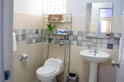 a small bathroom with a toilet and a sink at Apartamento entero en Samaná Los tios 1 y 2 in Santa Bárbara de Samaná