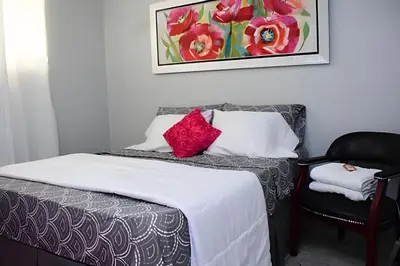 a bedroom with a bed and a chair at Apartamento entero en Samaná Los tios 1 y 2 in Santa Bárbara de Samaná
