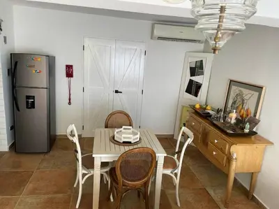 a kitchen with a table and chairs and a refrigerator at Amazing apartment, B-Juan Dolio, El Bonio II in Juan Dolio
