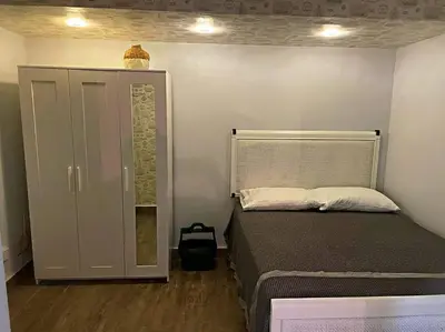 a small bedroom with a bed and a cabinet at Amazing apartment, B-Juan Dolio, El Bonio II in Juan Dolio