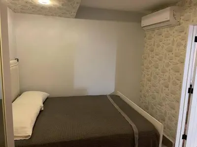 a small bedroom with a bed and a air conditioner at Amazing apartment, B-Juan Dolio, El Bonio II in Juan Dolio