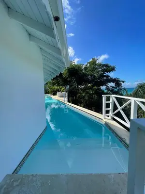 a swimming pool with a view of the ocean at ITAKA LOMA BONITA in Las Terrenas