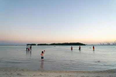 a group of people in the water at the beach at Villa Gumio 2BR Apt- 7 min walk to Boca Chica Beach apts in Boca Chica