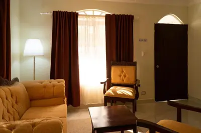 a living room with a couch and a chair at Villa Gumio 2BR Apt- 7 min walk to Boca Chica Beach apts in Boca Chica