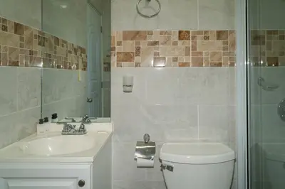 a bathroom with a toilet and a sink and a shower at Villa Gumio 2BR Apt -7min walk Boca Chica Beach apts in Boca Chica