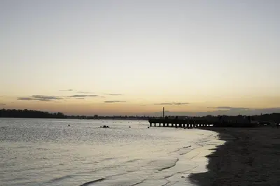 a beach with a pier in the water at Villa Gumio 2BR Apt -7min walk Boca Chica Beach apts in Boca Chica