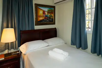 a bedroom with a bed with two white towels on it at Villa Gumio 2BR Apt -7min walk Boca Chica Beach apts in Boca Chica