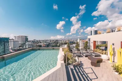 a swimming pool on the roof of a building at Breakfast Included at Regatta Living 605 in Los Prados