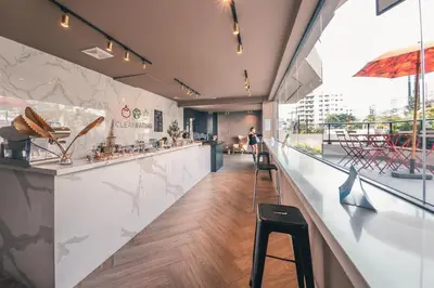 a restaurant with a counter and a bar with stools at Breakfast Included at Regatta Living 605 in Los Prados