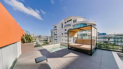 an apartment balcony with a view of a building at Regatta Living II with Breakfast Included! - 502 in Los Prados