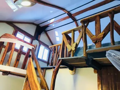 a wooden staircase in a room with wooden beams at Baby Rustic in Punta Rucia