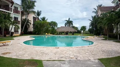 a swimming pool in front of a house at Laguna Golf in Punta Cana